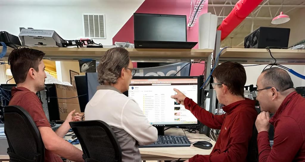 IT Services & Support for Churches 5 IT professionals reviewing backup and disaster recovery data on a computer monitor in an office environment
